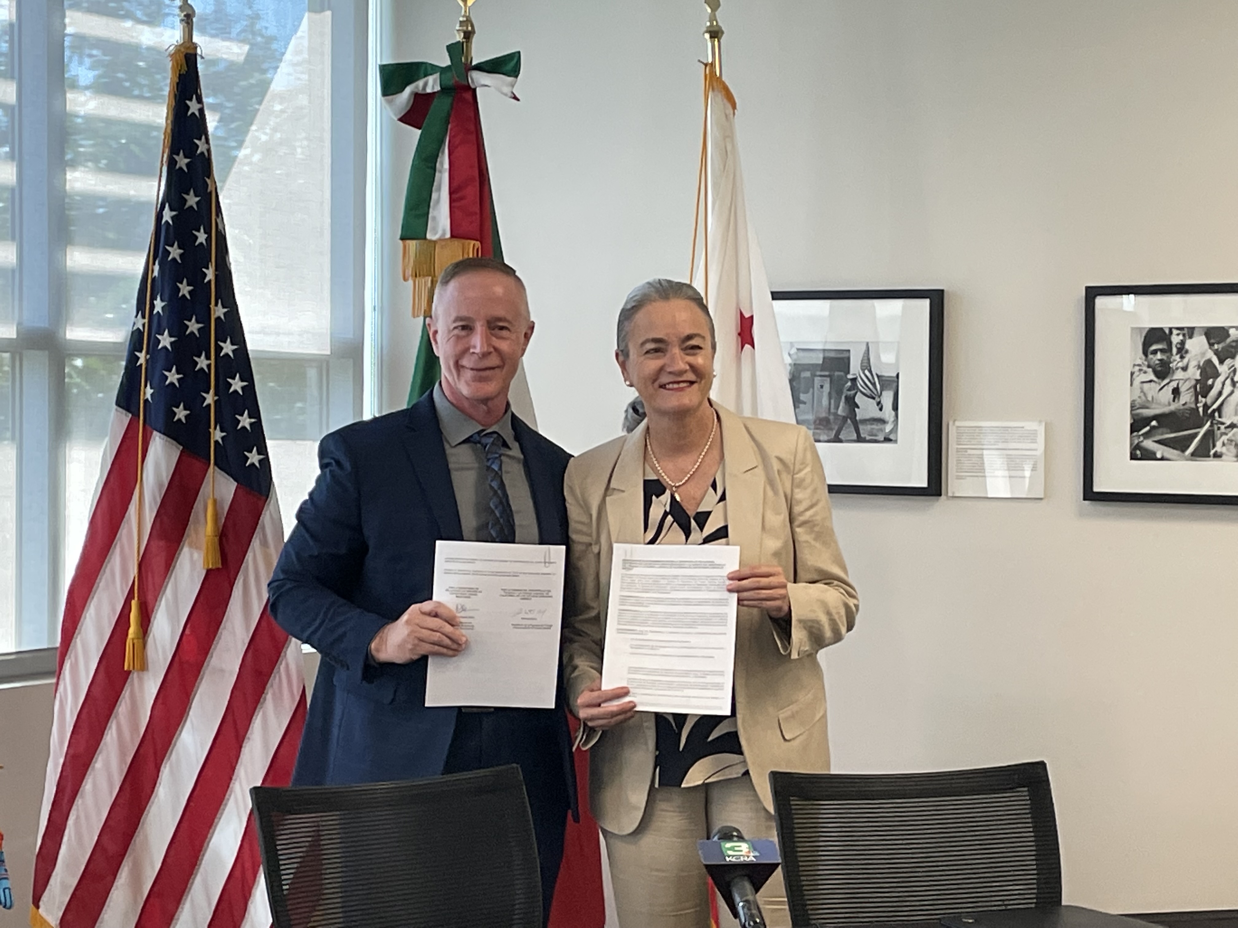 California Labor Secretary Stewart Knox and Consul General Liliana Ferrer holding the signed MOU.