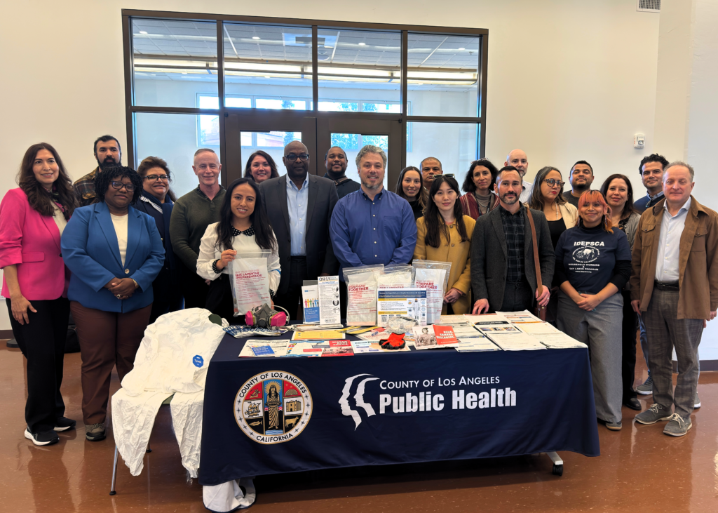 Group photo of LWDA Secretary Stewart Knox and Cal/OSHA Chief Debra Lee with community partners